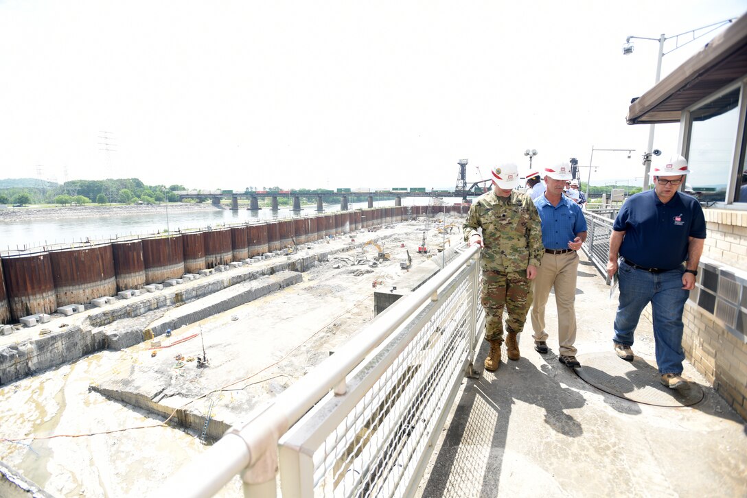 Lt. Col. Cullen Jones (Left), U.S. Army Corps of Engineers Nashville District commander, and Tommy Long (Right), resident engineer for the Chickamauga Lock Replacement Project, lead Vice Adm. Charles Ray, U.S. Coast Guard deputy commandant for Operations, on a tour above a coffer dam at Tennessee River mile 471 where excavation work is ongoing to remove 100,000 cubic yards of rock from the riverbed. Long explained that there have been about 130 blasts so far with about a third of the excavation work completed. Ray, the incoming assistant commandant of the Coast Guard, visited the lock in Chattanooga, Tenn., May 4, 2018. (USACE Photo by Lee Roberts)