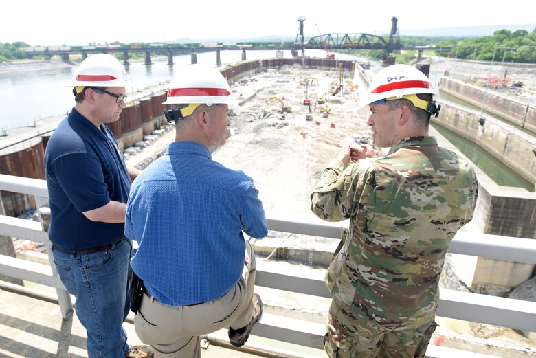 Lt. Col. Cullen Jones (Right), U.S. Army Corps of Engineers Nashville District commander, and Tommy Long (Left), resident engineer for the Chickamauga Lock Replacement Project, update Vice Adm. Charles Ray, U.S. Coast Guard deputy commandant for Operations, on the ongoing excavation work to remove 100,000 cubic yards of rock from the riverbed. Long explained that there have been about 130 blasts so far with about a third of the excavation work completed. Ray, the incoming assistant commandant of the Coast Guard, visited the lock at Tennessee River mile 471 in Chattanooga, Tenn., May 4, 2018. (USACE Photo by Lee Roberts)