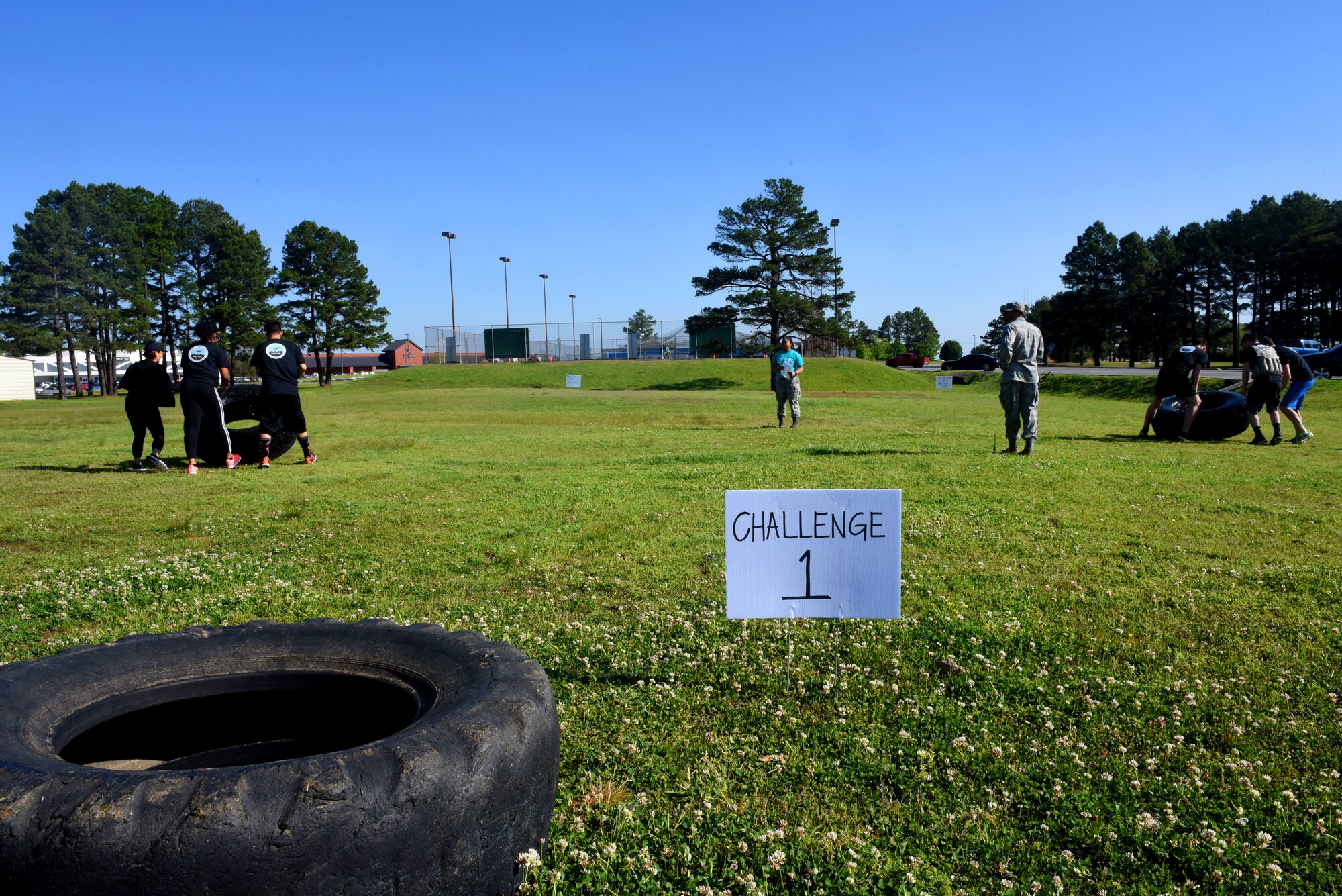 A CLEAR Challenge team starts the first obstacle which is flipping tires from on point to another.