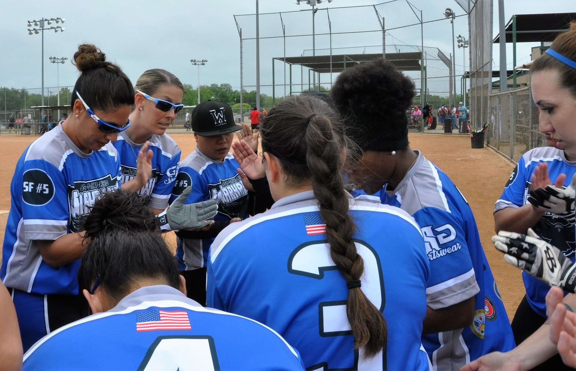 The JBSA-Lackland Warhawks women’s softball team huddles for a motivational moment before their game begins. (U.S. Air Force photo by Debbie Gildea)