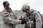 Staff Sgt. Paul Willey (left), an instructor at the Army’s Northern Warfare Training Center in Alaska, inspects a student’s equipment during the Basic Mountaineering Course.