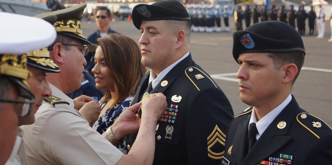 Sgt. 1st Class Michael Kinzie receives the Medalla Monja Blanca (Medal of the White Nun) from aGuatemalan general officer.