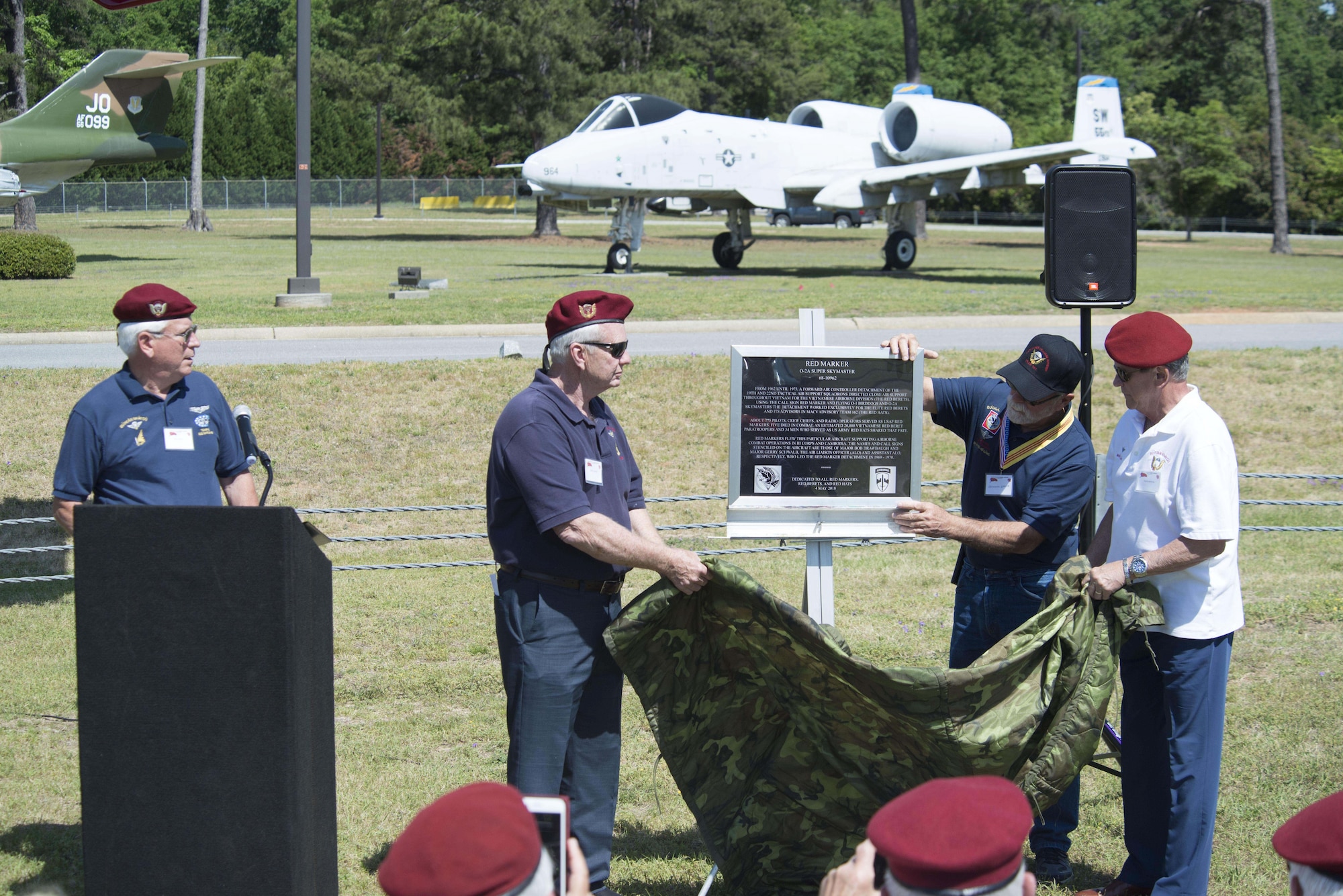 Members of the Society of the Vietnamese Airborne unveil a rededicated plaque for the O-2 Skymaster static display at Shaw Air Force Base, S.C., May 4, 2018.