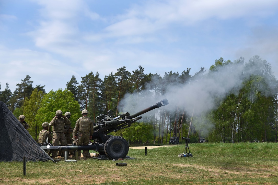 Soldiers fire an M119 105mm howitzer during a live-fire exercise.