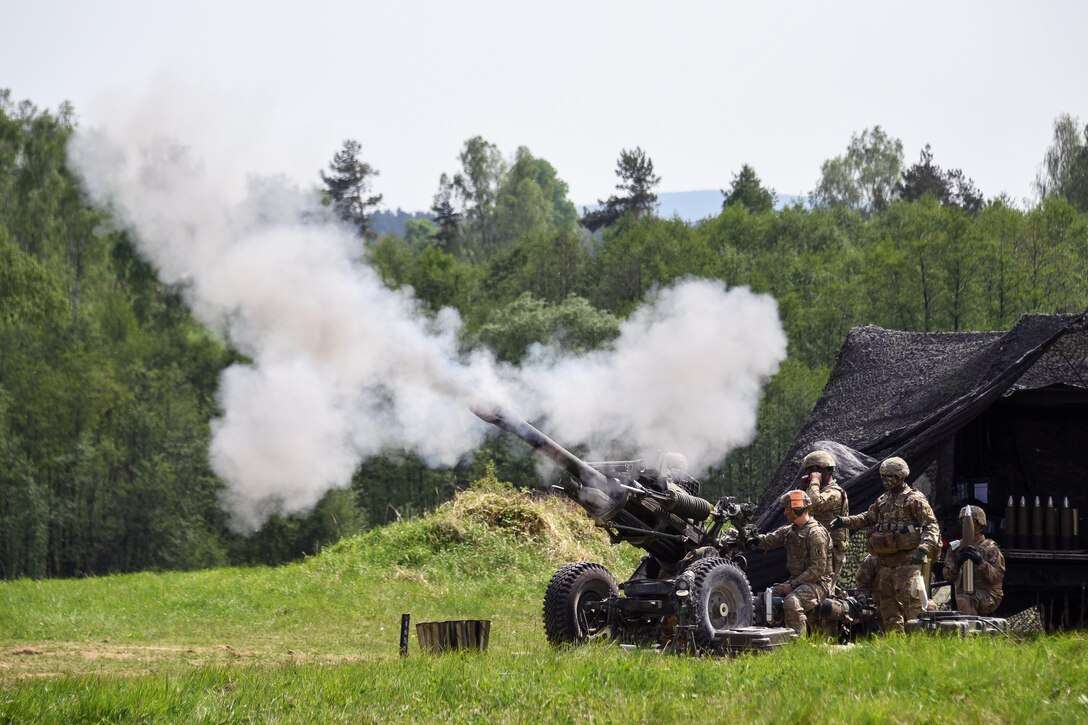 Soldiers fire an M119 105mm howitzer during a live-fire exercise.