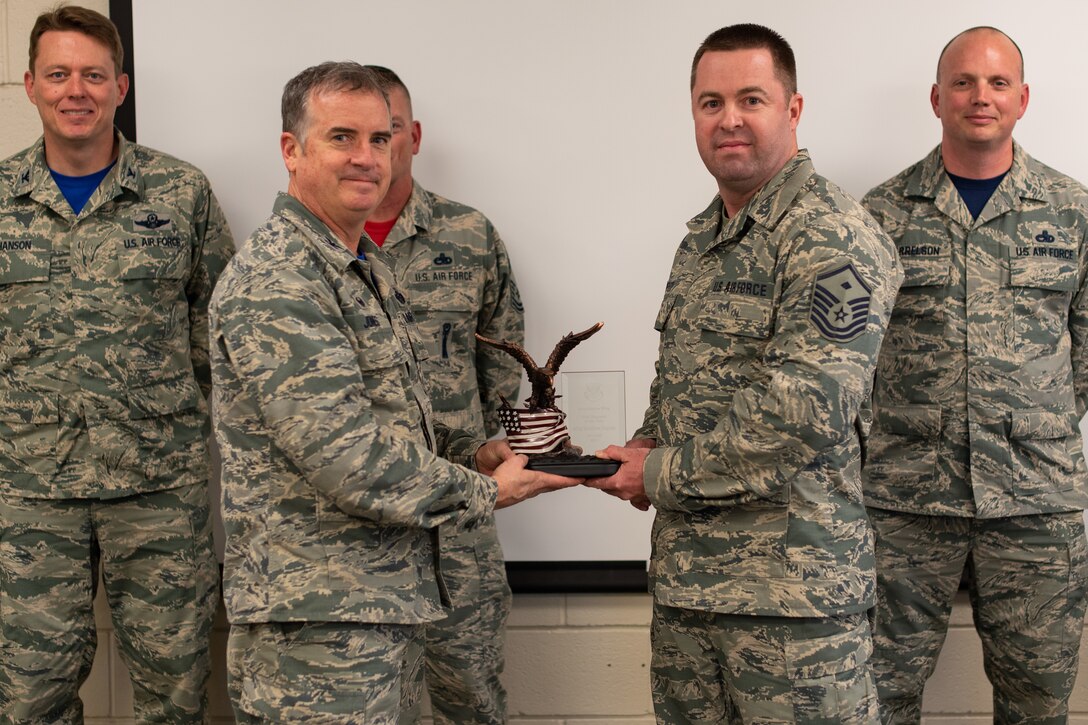 Col. Gregory Jones, 301st Fighter Wing commander, presents Master Sgt. Matthew Deputy, 301st Civil Engineer Squadron first sergeant, with the First Sergeant of the Year award May 6, 2018 during a visit to the squadron at Naval Air Station Fort Worth Joint Reserve Base, Texas. The wing’s annual award winners are among the best of the best and standout examples of Reserve Citizen Airmen. (U.S. Air Force photo by Master Sgt. Joshua Woods)