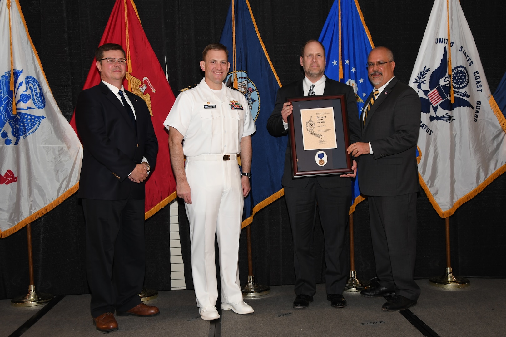 IMAGE: John Jims is presented the Bernard Smith Award at Naval Surface Warfare Center Dahlgren Division's annual awards ceremony, Apr. 26 at the Fredericksburg Expo and Conference Center.