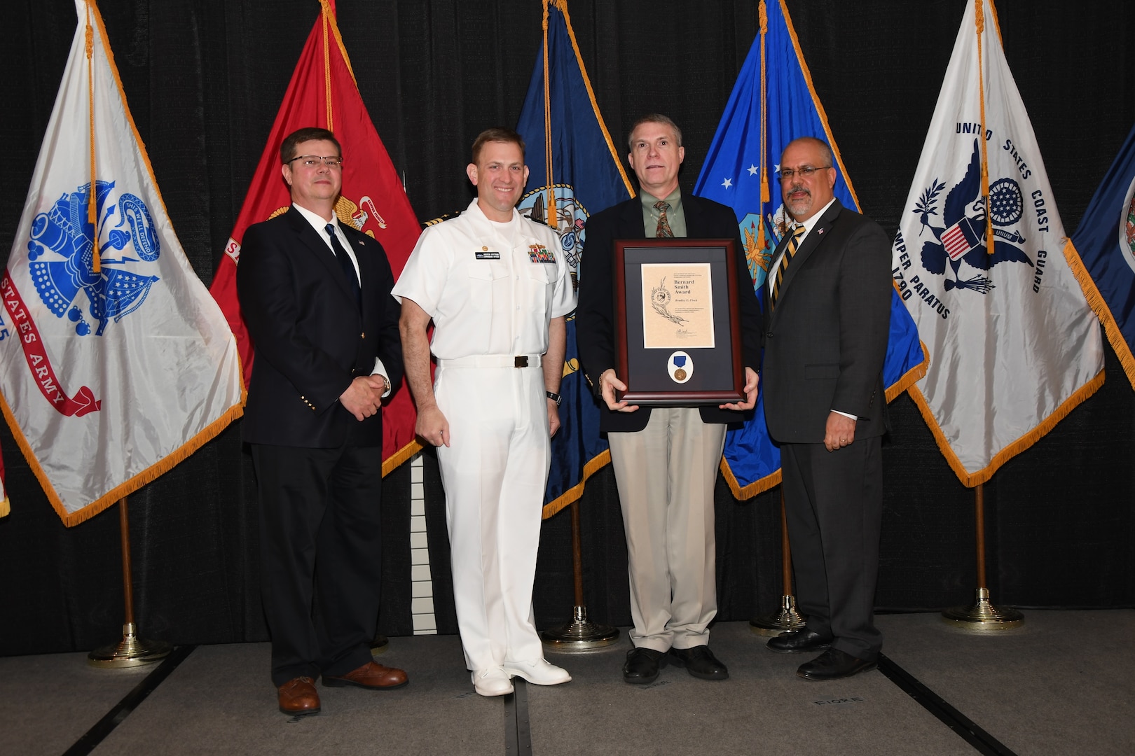 IMAGE: Bradley Flock is presented the Bernard Smith Award at Naval Surface Warfare Center Dahlgren Division's annual awards ceremony, Apr. 26 at the Fredericksburg Expo and Conference Center.