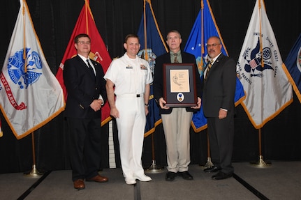 IMAGE: Bradley Flock is presented the Bernard Smith Award at Naval Surface Warfare Center Dahlgren Division's annual awards ceremony, Apr. 26 at the Fredericksburg Expo and Conference Center.