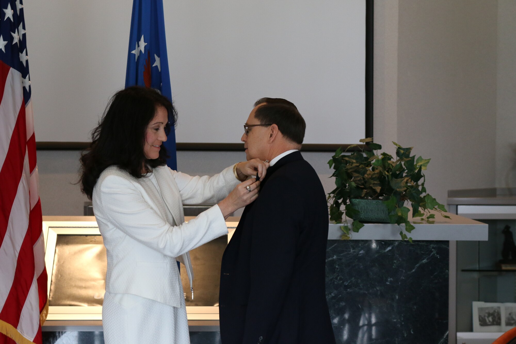 Dr. Mark Mehalic receives his Senior Executive Service pin from his wife Margarita. A ceremony to honor Mehalic for recent appointment to the SES was held at Arnold Air Force Base on April 19. Mehalic, who previously served at Arnold Air Force Base as AEDC executive director and vice director, is now the deputy director of Air, Space and Cyberspace Operations at AFMC. (U.S. Air Force photo/Bradley Hicks)