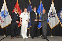 IMAGE: Kevin Cogley is presented the Employee Development Award at Naval Surface Warfare Center Dahlgren Division's annual awards ceremony, Apr. 26 at the Fredericksburg Expo and Conference Center.

The Employee Development Award was established to recognize those individuals who – through their leadership and commitment – have made exemplary contributions to the development of others.