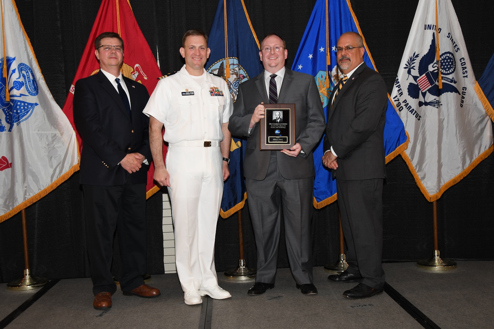 IMAGE: William Moore is presented the Dr. Charles J. Cohen Award at Naval Surface Warfare Center Dahlgren Division's annual awards ceremony, Apr. 26 at the Fredericksburg Expo and Conference Center.

The award recognizes those who fundamentally impact science or technology with work that also measurably impacts capability.