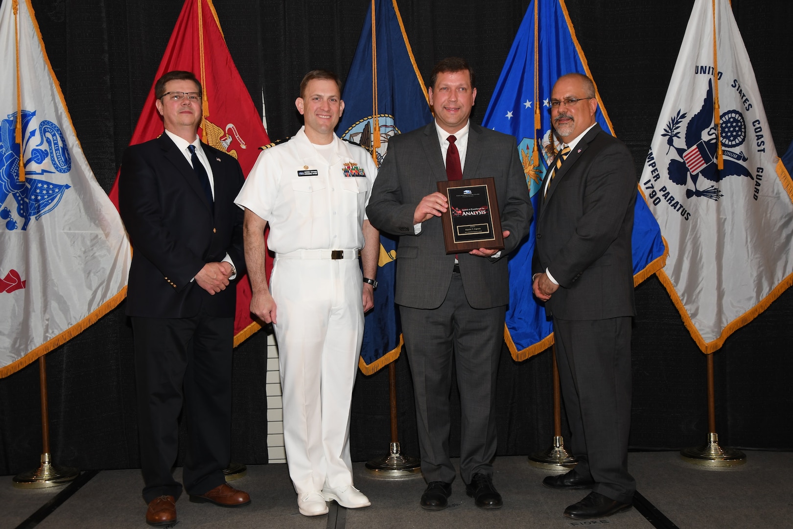IMAGE: Martin Capone is presented the NSWCDD Award of Excellence for Analysis at Naval Surface Warfare Center Dahlgren Division's annual awards ceremony, Apr. 26 at the Fredericksburg Expo and Conference Center.

The NSWCDD Award of Excellence for Analysis is newly established to recognize individuals who have made a notable and significant impact to NSWCDD through their outstanding performance in analysis - warfare, design, engineering, modeling and simulation.