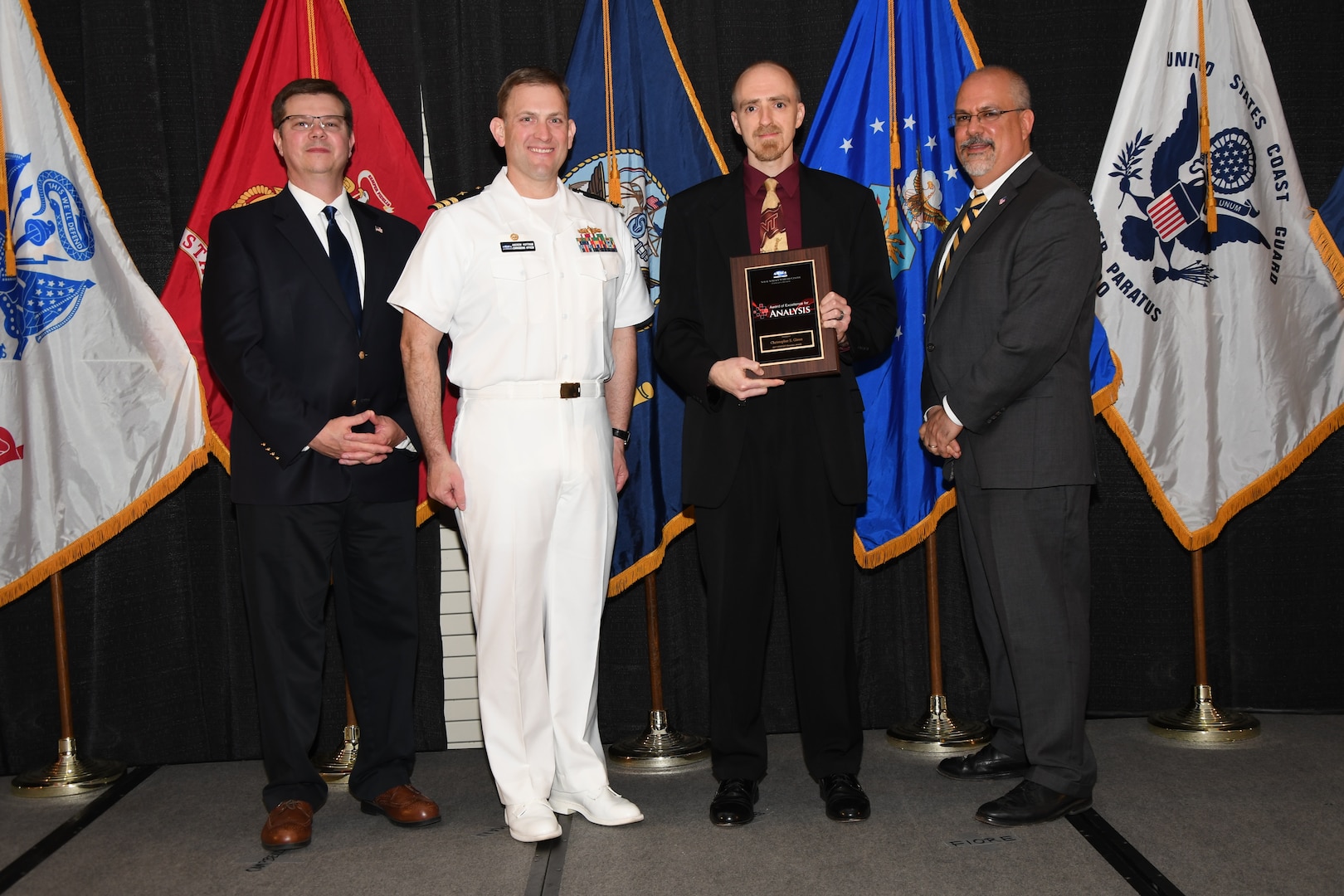 IMAGE: Christopher Glenn is presented the NSWCDD Award of Excellence for Analysis at Naval Surface Warfare Center Dahlgren Division's annual awards ceremony, Apr. 26 at the Fredericksburg Expo and Conference Center.

The NSWCDD Award of Excellence for Analysis is newly established to recognize individuals who have made a notable and significant impact to NSWCDD through their outstanding performance in analysis - warfare, design, engineering, modeling and simulation.