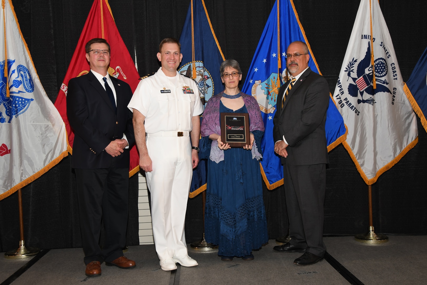 IMAGE: Carolyn Blakelock is presented the NSWCDD Award of Excellence for Analysis at Naval Surface Warfare Center Dahlgren Division's annual awards ceremony, Apr. 26 at the Fredericksburg Expo and Conference Center.

The NSWCDD Award of Excellence for Analysis is newly established to recognize individuals who have made a notable and significant impact to NSWCDD through their outstanding performance in analysis - warfare, design, engineering, modeling and simulation.
