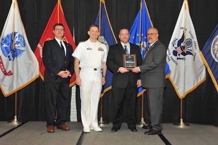 IMAGE: Micah Colon is presented the  NSWCDD Award of Excellence for Software Engineering and Integration at Naval Surface Warfare Center Dahlgren Division's annual awards ceremony, Apr. 26 at the Fredericksburg Expo and Conference Center.

The NSWCDD Award of Excellence for Software Engineering and Integration was established to recognize individuals who have made a notable and significant impact to NSWCDD through their outstanding performance in Software Engineering & Integration.