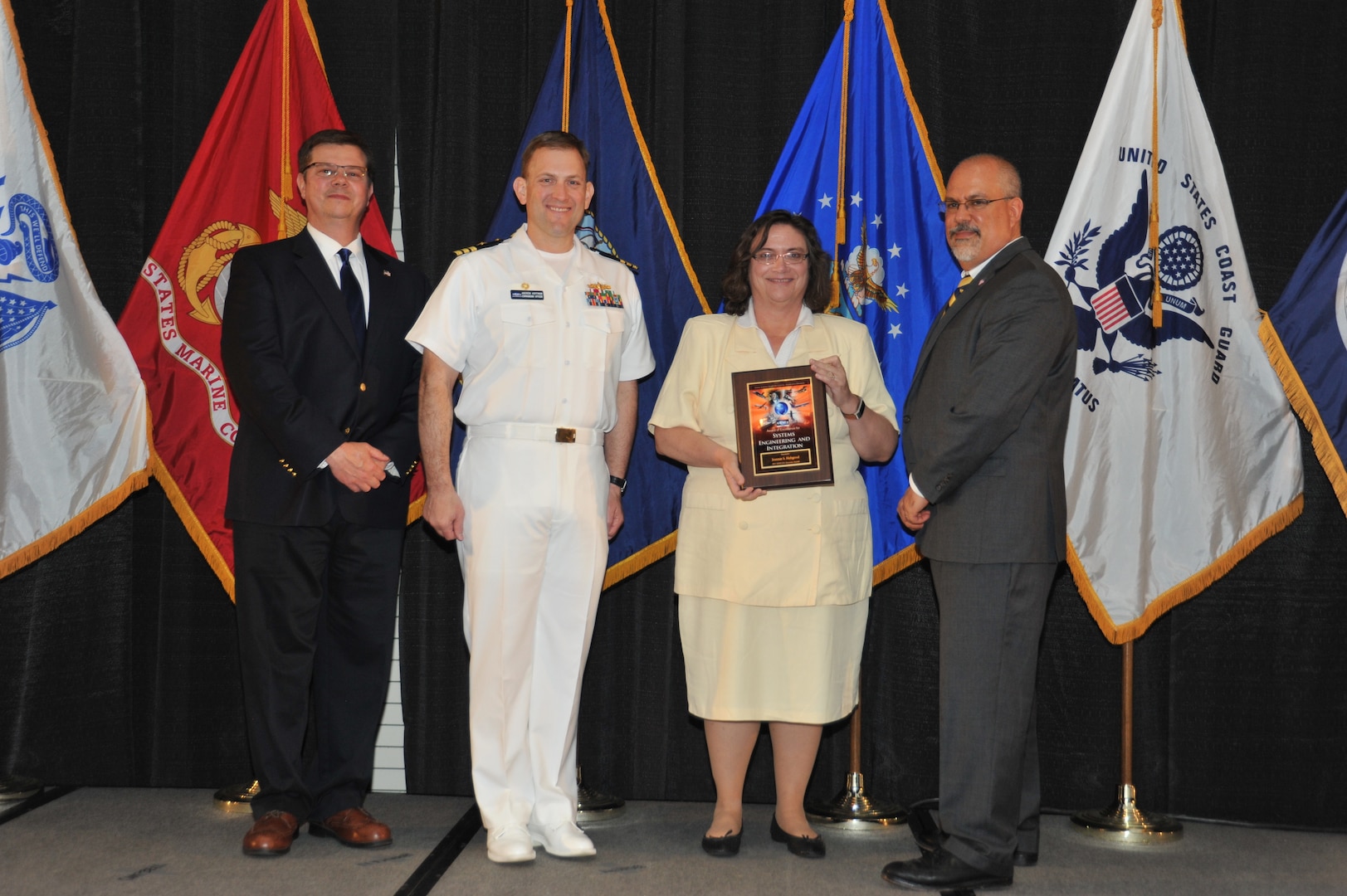IMAGE: Jeannie Hobgood is presented the Award of Excellence for Systems Engineering and Integration at Naval Surface Warfare Center Dahlgren Division's annual awards ceremony, Apr. 26 at the Fredericksburg Expo and Conference Center.

The Award of Excellence for Systems Engineering and Integration was established to recognize individuals who have made a notable and significant impact to NSWCDD through their outstanding performance in systems engineering and integration.
