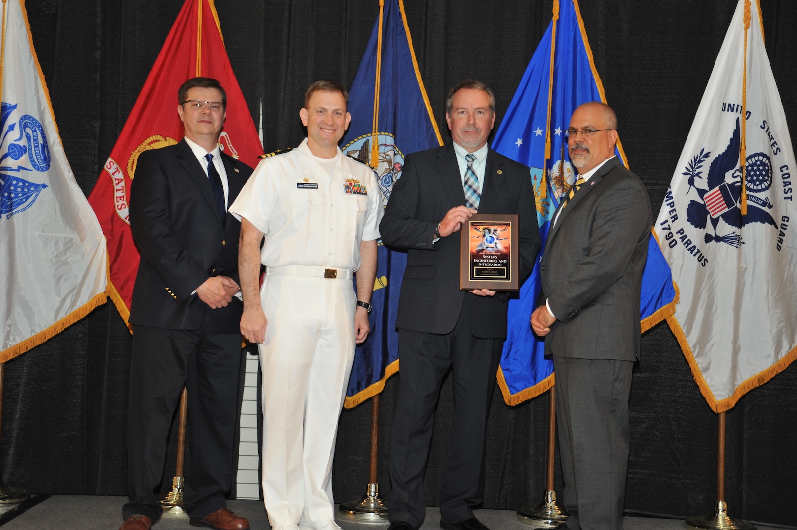 IMAGE: Robert Turner is presented the Award of Excellence for Systems Engineering and Integration at Naval Surface Warfare Center Dahlgren Division's annual awards ceremony, Apr. 26 at the Fredericksburg Expo and Conference Center.

The Award of Excellence for Systems Engineering and Integration was established to recognize individuals who have made a notable and significant impact to NSWCDD through their outstanding performance in systems engineering and integration.