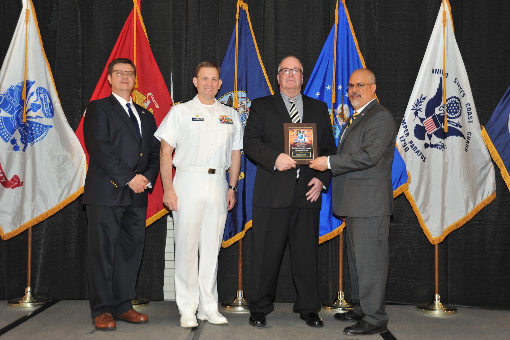 IMAGE: Claiborne Doxey is presented the Award of Excellence for Systems Engineering and Integration at Naval Surface Warfare Center Dahlgren Division's annual awards ceremony, Apr. 26 at the Fredericksburg Expo and Conference Center.

The Award of Excellence for Systems Engineering and Integration was established to recognize individuals who have made a notable and significant impact to NSWCDD through their outstanding performance in systems engineering and integration.