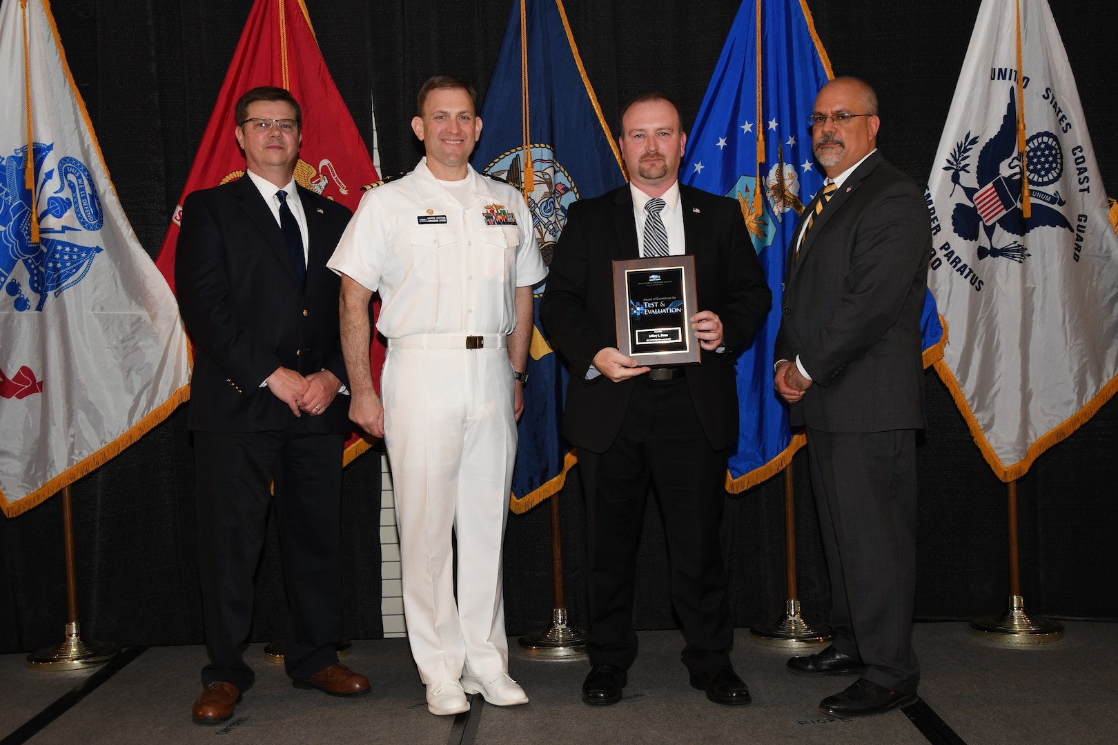 IMAGE: Jeffrey Bunn is presented the NSWCDD Award of Excellence for Test & Evaluation at Naval Surface Warfare Center Dahlgren Division's annual awards ceremony, Apr. 26 at the Fredericksburg Expo and Conference Center.

The NSWCDD Award of Excellence for Test & Evaluation was established to recognize individuals who have made a notable and significant impact to NSWCDD through their outstanding performance in Test and Evaluation, the collection, analysis, and assessment of data to characterize and/or measure the performance of a component, system, platform, or mission.