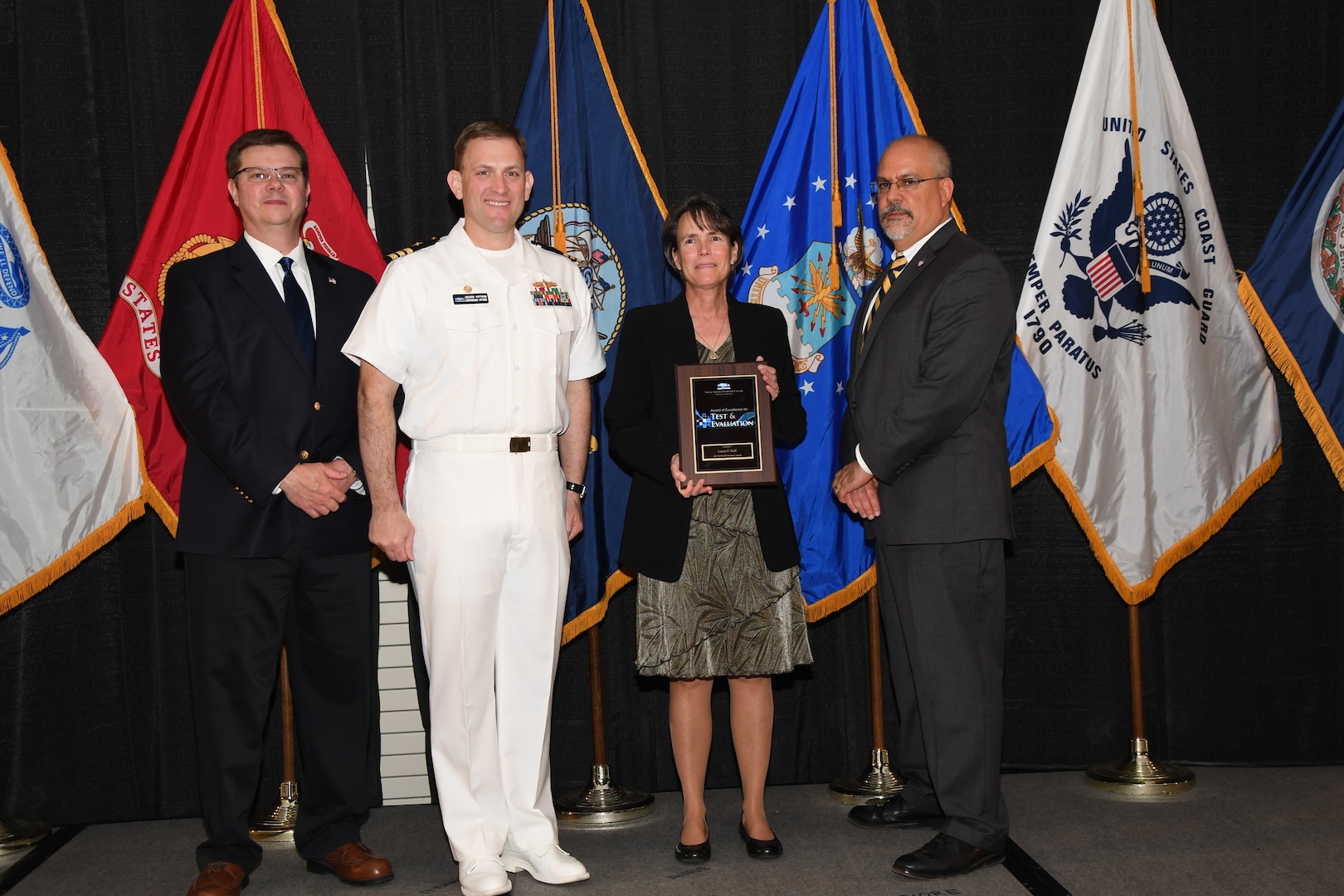 IMAGE: Laura Ruff is presented the NSWCDD Award of Excellence for Test & Evaluation at Naval Surface Warfare Center Dahlgren Division's annual awards ceremony, Apr. 26 at the Fredericksburg Expo and Conference Center.

The NSWCDD Award of Excellence for Test & Evaluation was established to recognize individuals who have made a notable and significant impact to NSWCDD through their outstanding performance in Test and Evaluation, the collection, analysis, and assessment of data to characterize and/or measure the performance of a component, system, platform, or mission.