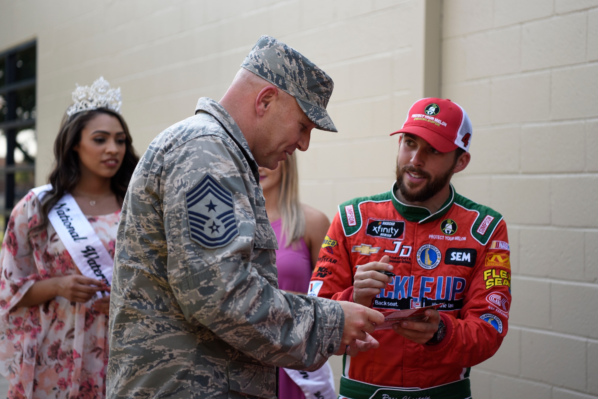 Chief Master Sgt. Anthony Green, 436th Airlift Wing command chief, gets an autograph from Ross Chastain, driver of the No. 15 Premium Motorsports Chevrolet Camaro car, May 4, 2018, at Dover Air Force Base, Del. Several NASCAR drivers attended May’s First Friday in Hangar 295 at the Landings to sign autographs and meet some of Team Dover’s Airmen. (U.S. Air Force photo by Airman 1st Class Zoe M. Wockenfuss)