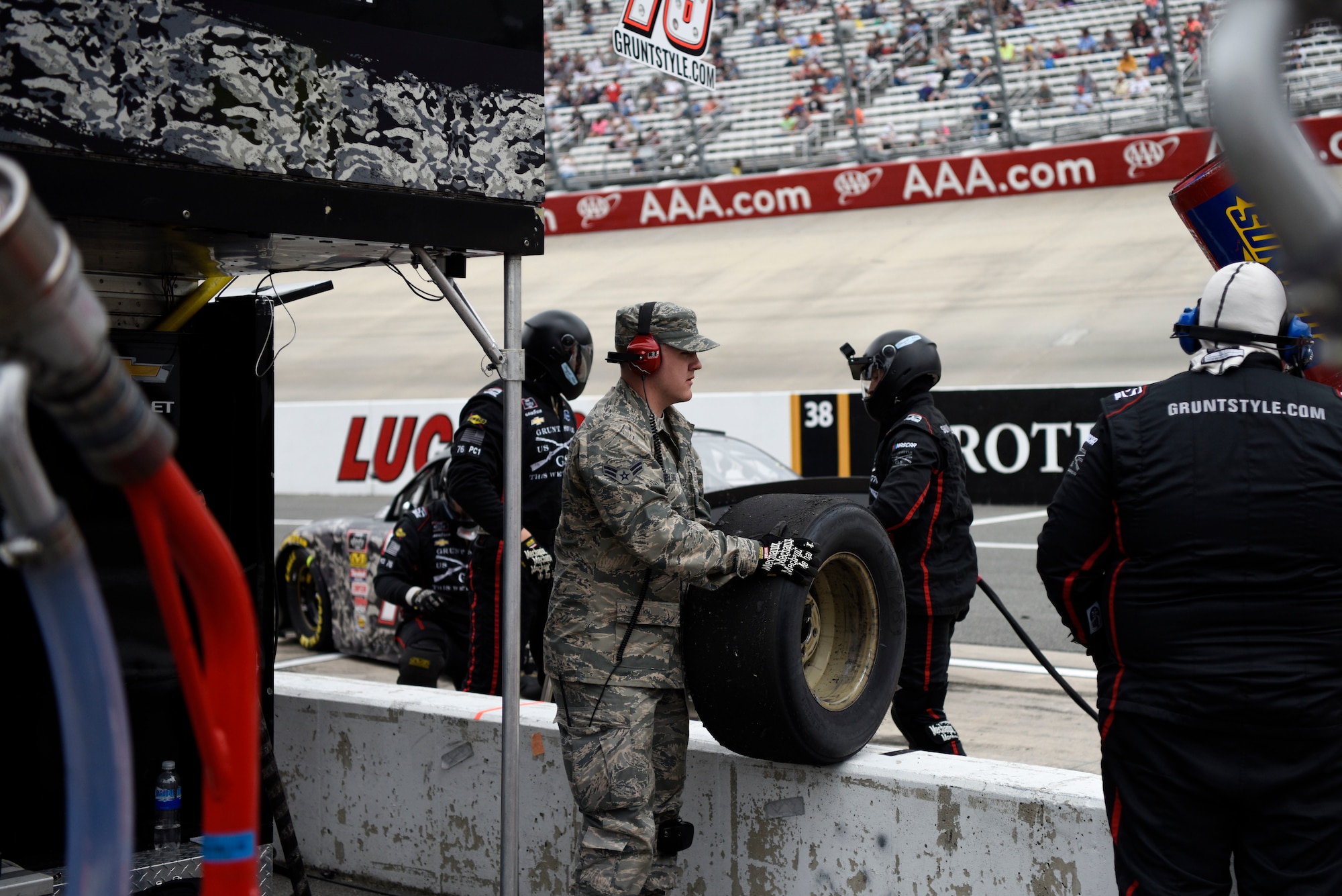 Airman 1st Class Lance Kielbaso, 436th Maintenance Squadron metals technician apprentice, watches a race as an honorary pit crew member for Spencer Boyd, driver of the No. 76 SS Green Light Racing Chevrolet Camaro car, during the “OneMain Financial 200” NASCAR XFINITY Series Dash 4 Cash Race May 5, 2018, at Dover International Speedway, Del. Kielbaso helped the crew with a tire change during a pit stop. (U.S. Air Force photo by Airman 1st Class Zoe M. Wockenfuss)