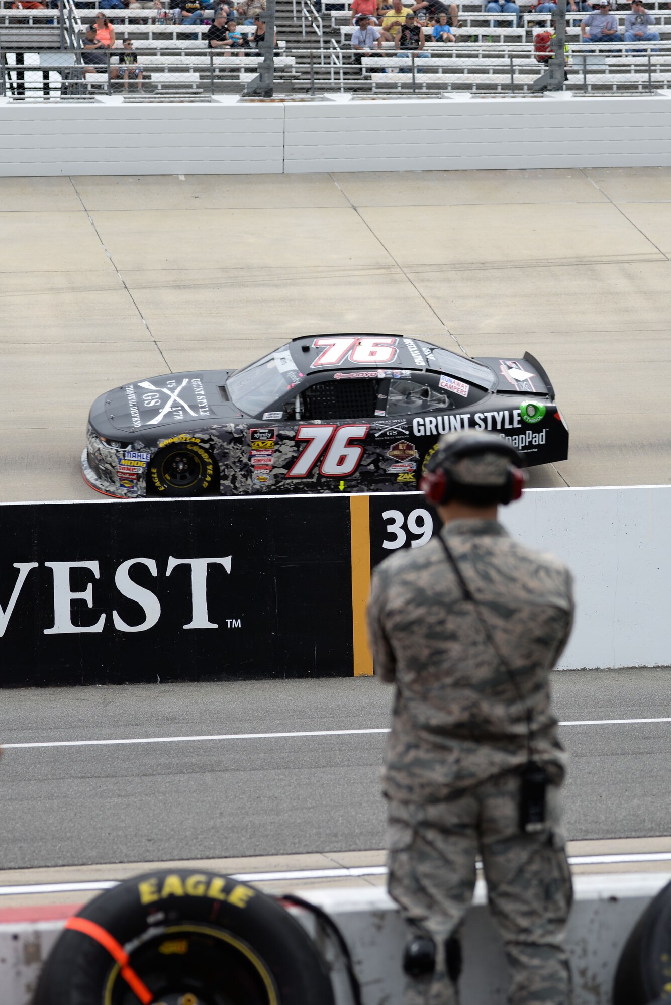 Airman 1st Class Christian Padilla, 436th Maintenance Squadron metals technician apprentice, watches the “OneMain Financial 200” NASCAR Xfinity Series Dash 4 Cash Race May 5, 2018, from inside a pit box at Dover International Speedway, Del. Padilla was an honorary pit crew member for Spencer Boyd, driver of the No. 76 SS Green Light Racing Chevrolet Camaro car. (U.S. Air Force photo by Airman 1st Class Zoe M. Wockenfuss)