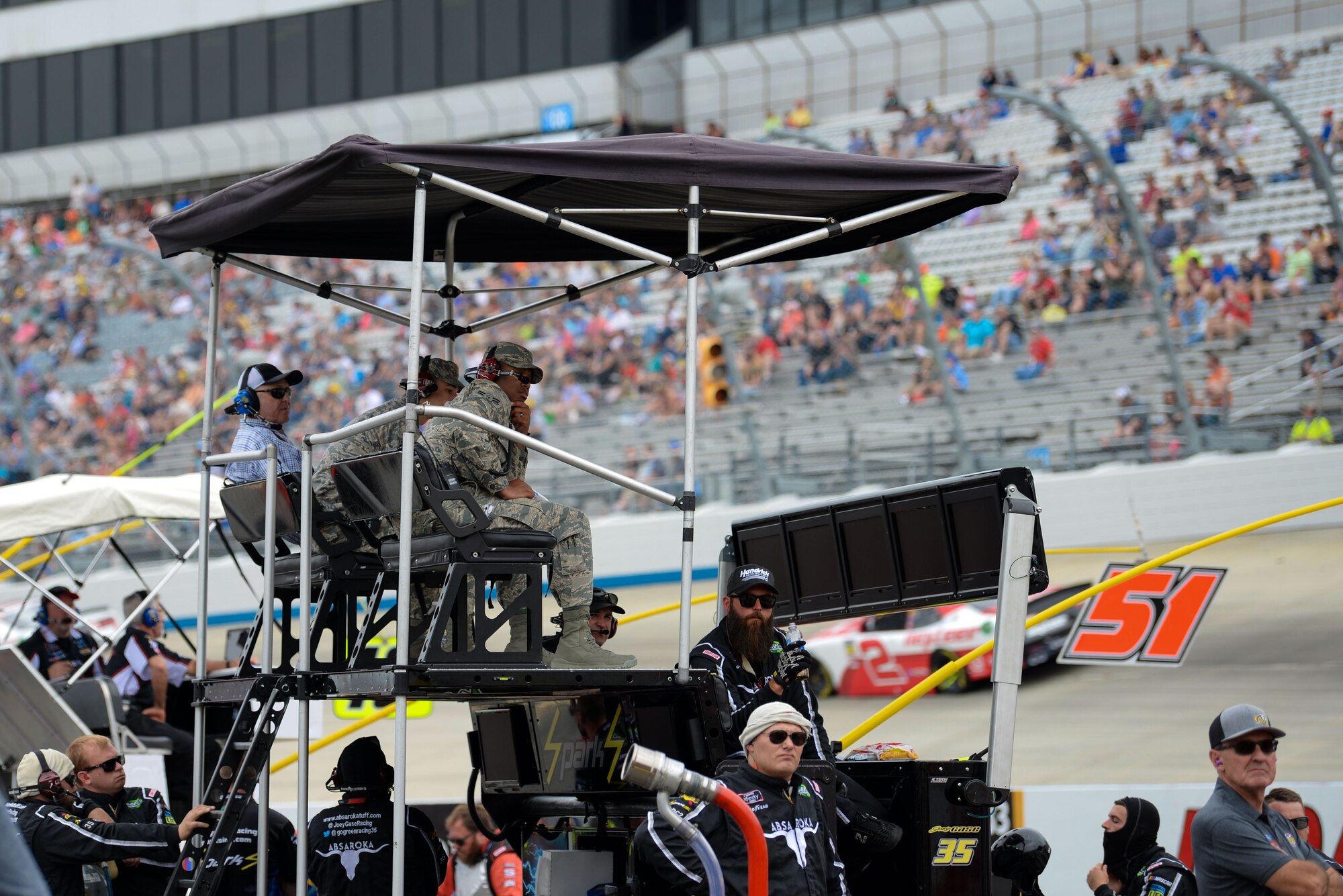 Airmen 1st Class Donnell Graham and Jefferson Buchanan, 436th Aerial Port Squadron freight documents specialist and cargo processor, experience the race from a pit crew member’s perspective at Dover International Speedway, Del., May 5, 2018. Graham and Buchanan accompanied the pit crew of Joey Gase, driver of the No. 35 SS Green Light Racing Chevrolet Camaro car, during the “OneMain Financial 200” NASCAR Xfinity Series Dash 4 Cash Race. (U.S. Air Force photo by Airman 1st Class Zoe M. Wockenfuss)