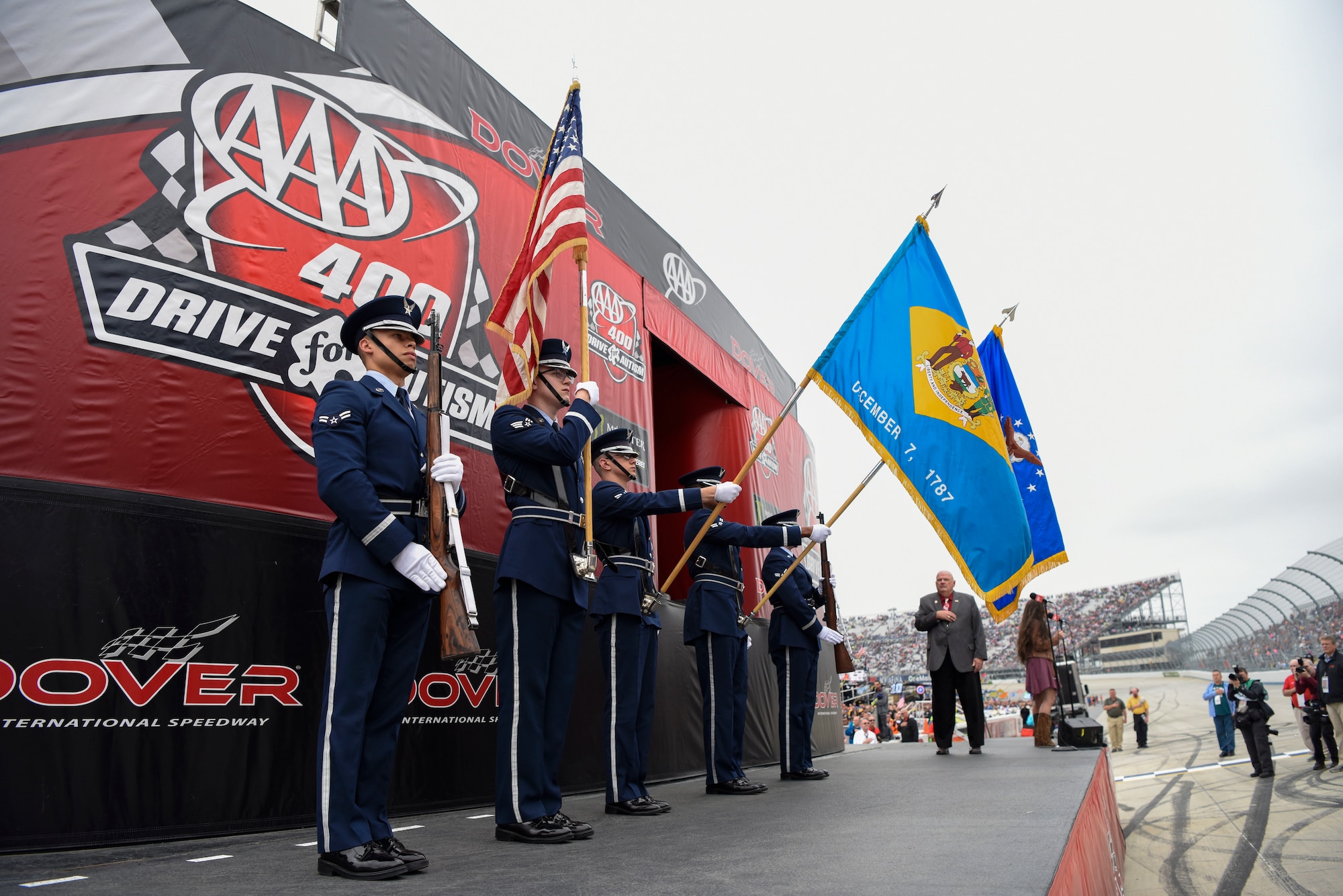 A Dover Air Force Base Honor Guard color guard team presents the colors at the beginning of the “AAA 400 Drive for Autism” Monster Energy NASCAR Cup Series Race May 6, 2018, at Dover International Speedway, Del. American Country music singer Jessica Lynn sang the national anthem and Dan Schafer, pastor of Calvary Assembly of God, Hightstown, N.J., gave the invocation. (U.S. Air Force photo by Airman 1st Class Zoe M. Wockenfuss)