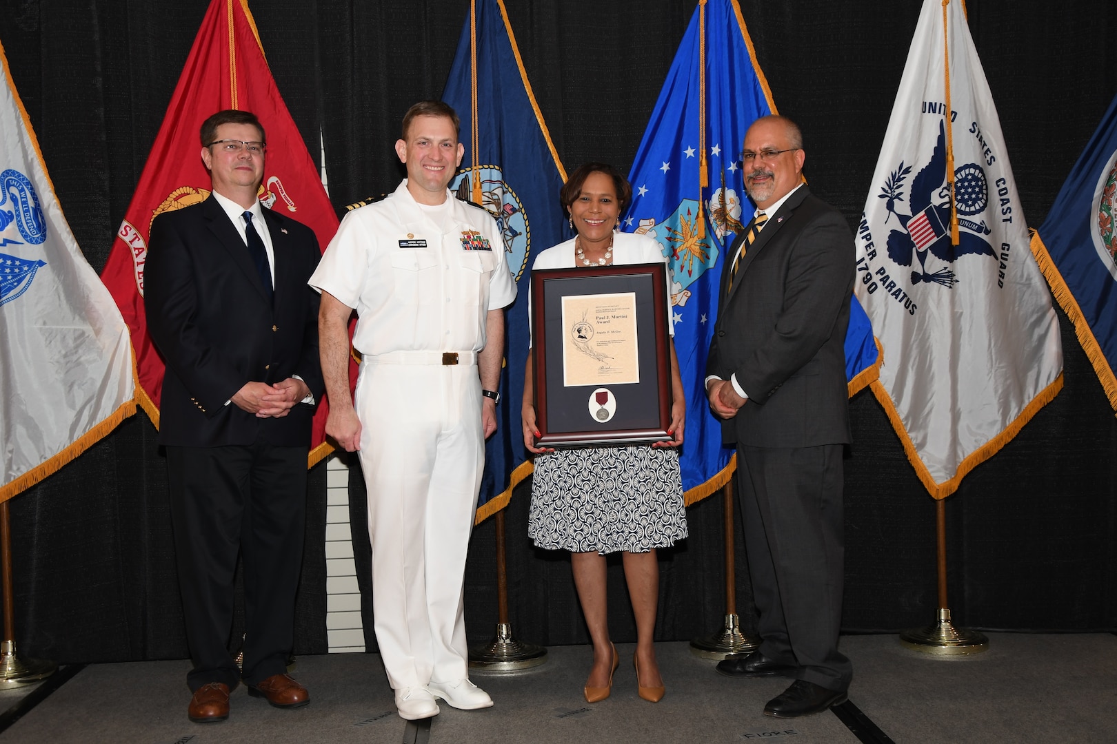 IMAGE: Angela McGee is presented the Paul J. Martini Award at Naval Surface Warfare Center Dahlgren Division's annual awards ceremony, Apr. 26 at the Fredericksburg Expo and Conference Center.

The award is named in honor of Paul J. Martini, who was head of the Engineering Support Directorate of the Naval Ordnance Laboratory from November 1951 to December 1973.