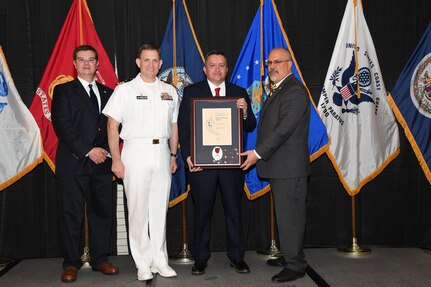IMAGE: Hector Minero is presented the Paul J. Martini Award at Naval Surface Warfare Center Dahlgren Division's annual awards ceremony, Apr. 26 at the Fredericksburg Expo and Conference Center.

The award is named in honor of Paul J. Martini, who was head of the Engineering Support Directorate of the Naval Ordnance Laboratory from November 1951 to December 1973.