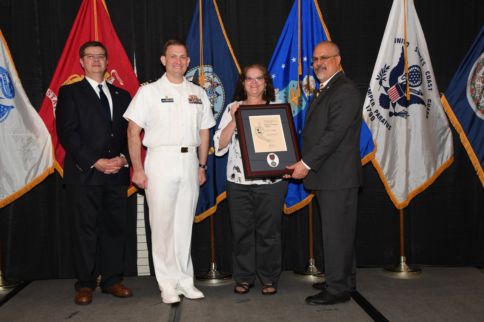 IMAGE: Debbie Newkirk is presented the Paul J. Martini Award at Naval Surface Warfare Center Dahlgren Division's annual awards ceremony, Apr. 26 at the Fredericksburg Expo and Conference Center.

The award is named in honor of Paul J. Martini, who was head of the Engineering Support Directorate of the Naval Ordnance Laboratory from November 1951 to December 1973.