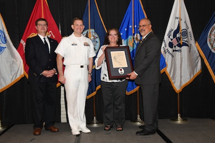 IMAGE: Debbie Newkirk is presented the Paul J. Martini Award at Naval Surface Warfare Center Dahlgren Division's annual awards ceremony, Apr. 26 at the Fredericksburg Expo and Conference Center.

The award is named in honor of Paul J. Martini, who was head of the Engineering Support Directorate of the Naval Ordnance Laboratory from November 1951 to December 1973.