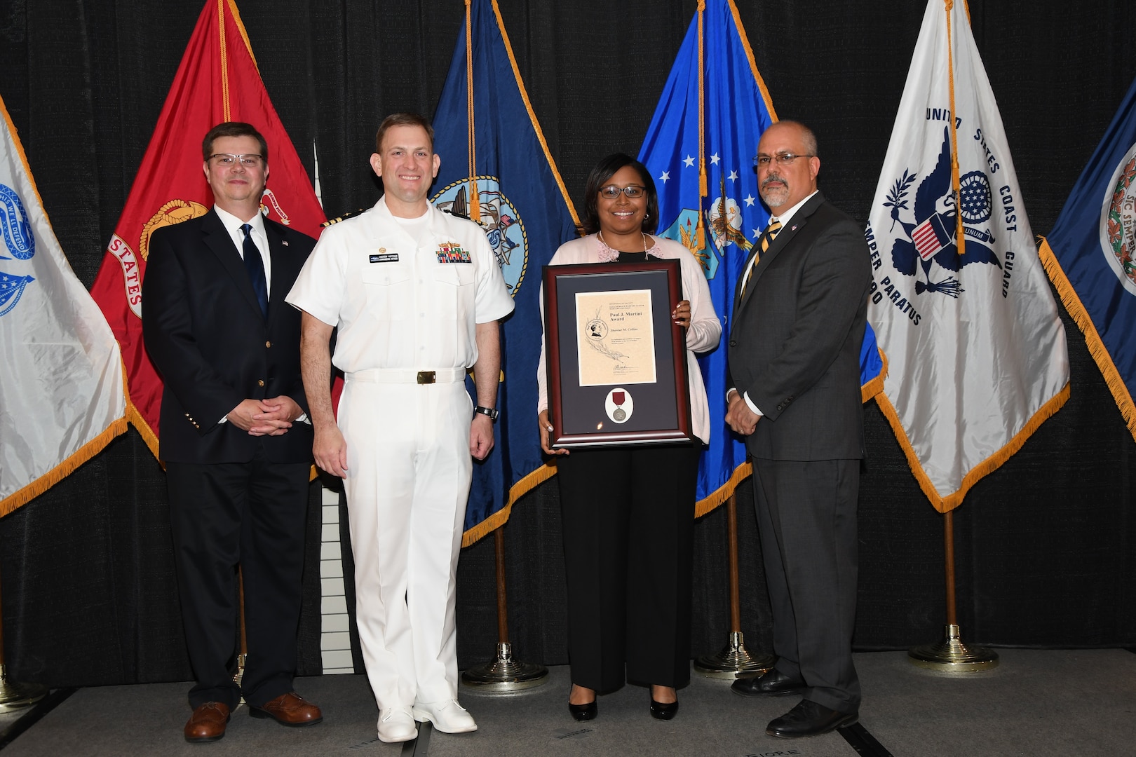 IMAGE: Shantae Collins is presented the Paul J. Martini Award at Naval Surface Warfare Center Dahlgren Division's annual awards ceremony, Apr. 26 at the Fredericksburg Expo and Conference Center.

The award is named in honor of Paul J. Martini, who was head of the Engineering Support Directorate of the Naval Ordnance Laboratory from November 1951 to December 1973.