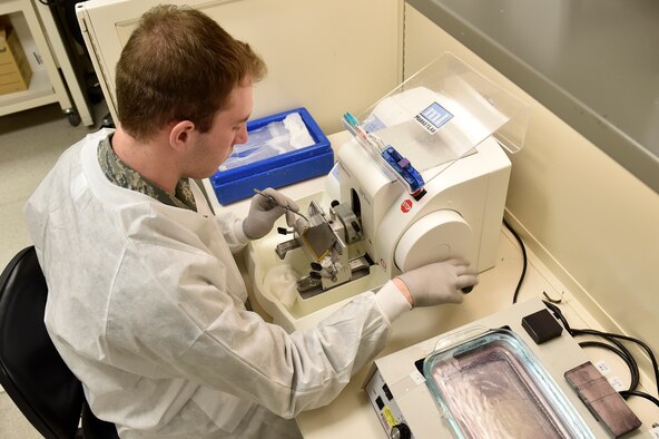 Airman 1st Class Anthony Lapiana, 60th Medical Diagnostics and Therapeutic Squadron histology technician, uses a microtome to cut samples of patient tissue, Feb. 15, 2018, Travis Air Force Base, Calif. After the tissue is processed it is transferred onto microscopic glass slides and studied by pathologists to make patients’ diagnosis. (U.S. Air Force photo by Tech. Sgt. Liliana Moreno/Released)
