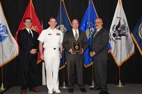 IMAGE: Curtis Dunn is presented the Distinguished Community Service Award at Naval Surface Warfare Center Dahlgren Division's annual awards ceremony, Apr. 26 at the Fredericksburg Expo and Conference Center.