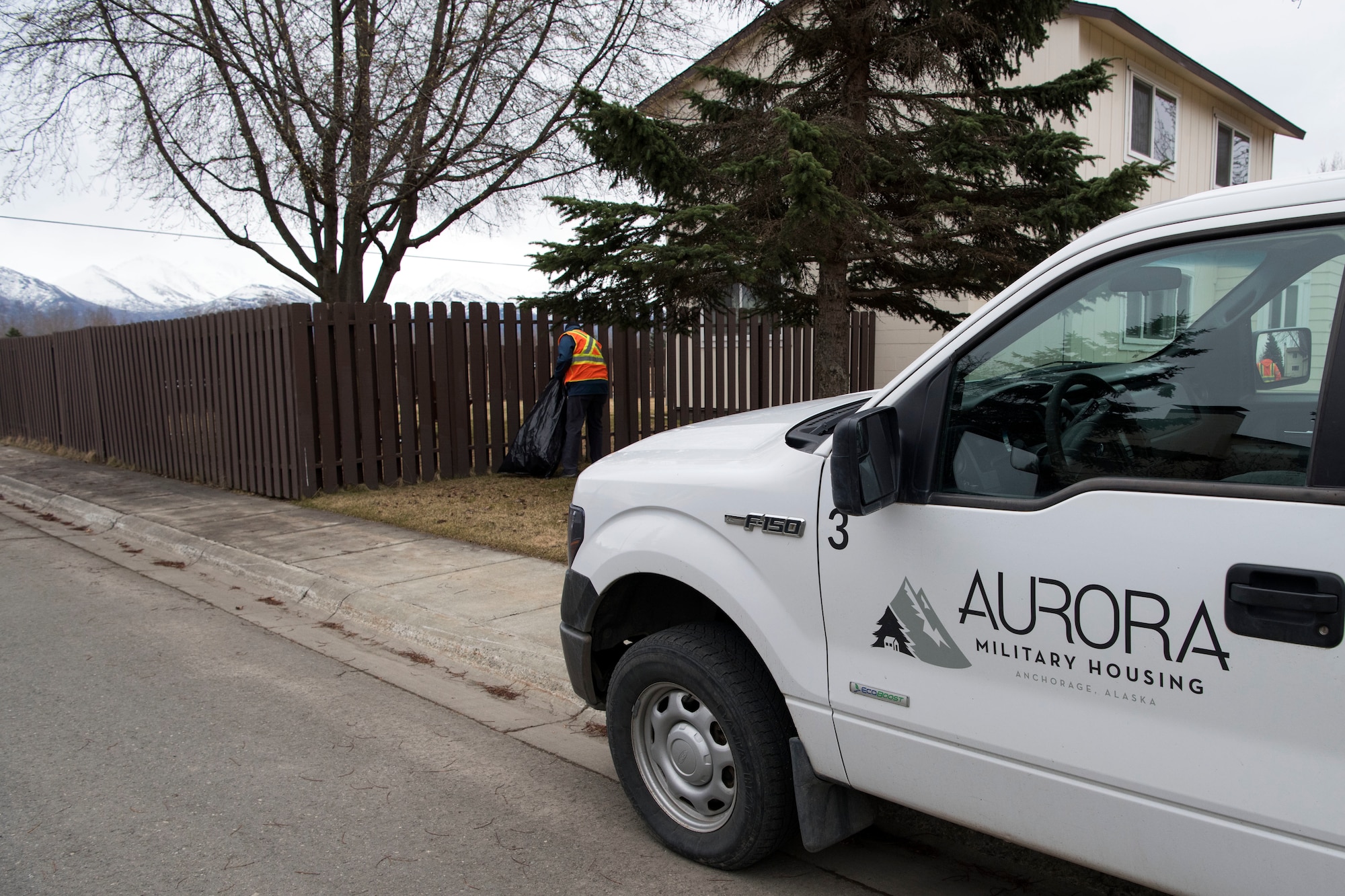Personnel with Aurora Military Housing scan for trash and debris as they walk in a neigborhood at Joint Base Elmendorf-Richardson, Alaska, May 3, 2018. JBER participated in Operation Clean Sweep in support of the Anchorage Chamber of Commerce's 50th Annual Citywide Cleanup campaign.