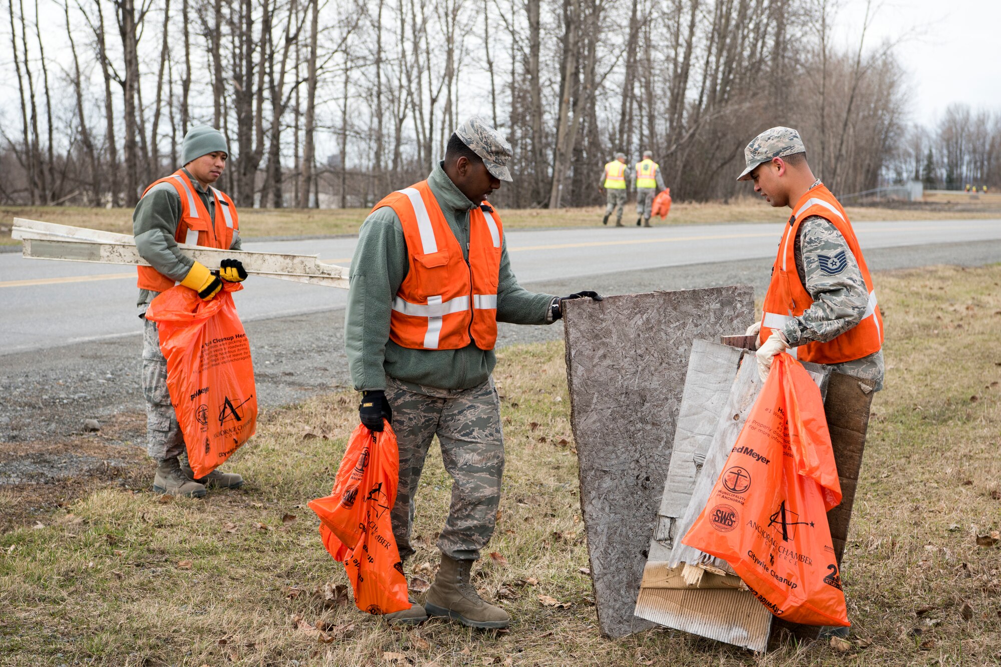 Airmen with the 773d Civil Engineer Squadron scan for trash and debris as they walk down a road at Joint Base Elmendorf-Richardson, Alaska, May 4, 2018. JBER participated in Operation Clean Sweep in support of the Anchorage Chamber of Commerce's 50th Annual Citywide Cleanup campaign.