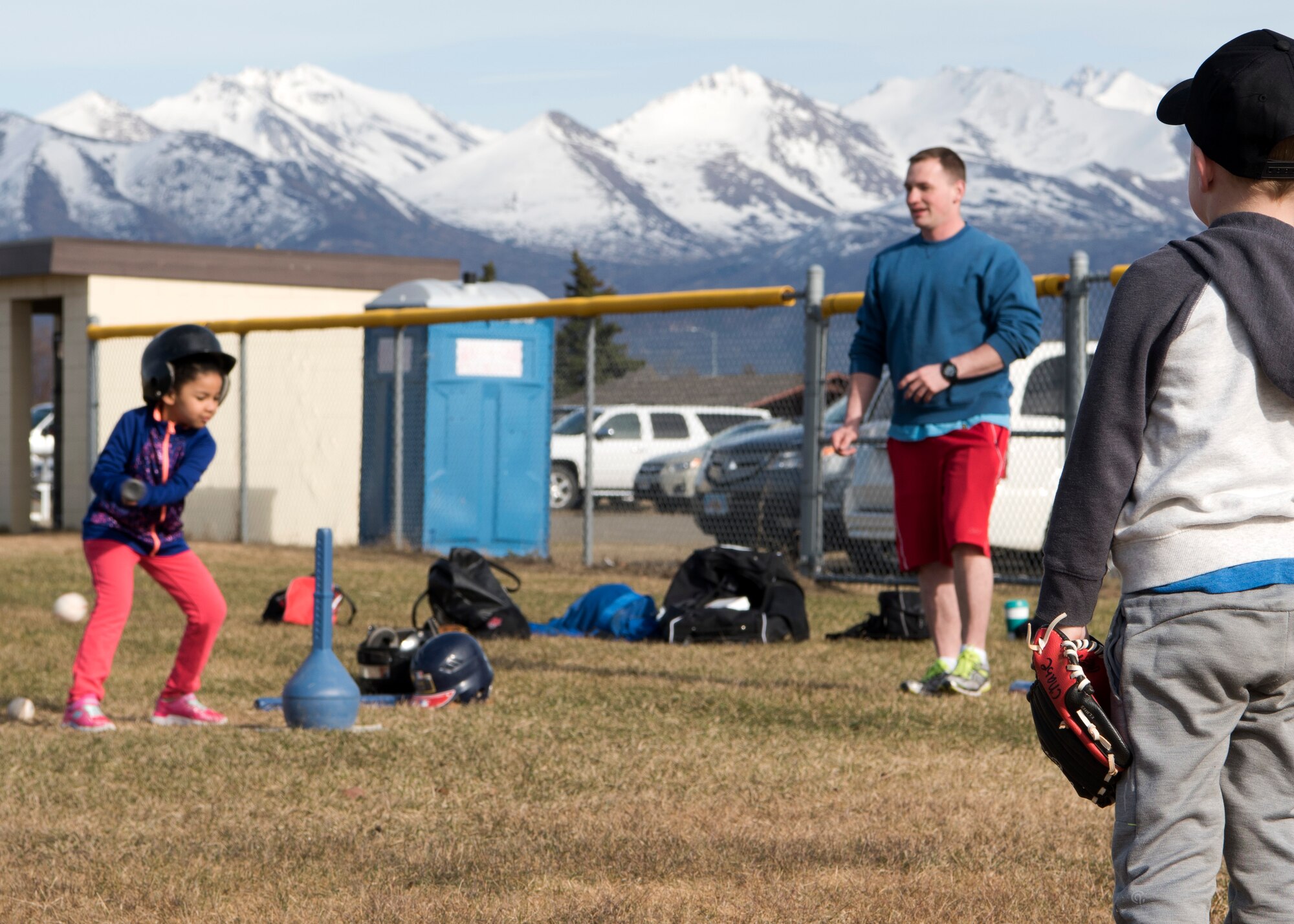 Chase, age 5, son of Air Force Maj. Jeff Van Horn, 732nd Aircraft Maintenance Squadron director of operations, listens to coaching while learning about playing an outfield position at Joint Base Elmendorf-Richardson, Alaska, May 7, 2018. JBER Youth Sports Program abides by the National Alliance for Youth Sports-affiliated National Youth Sports Coaches Association, which provides education on topics such as the psychology of coaching youth sports, communication, child abuse, injury prevention, and nutrition and hydration, as well as skills and drills specifically applicable to each sport.