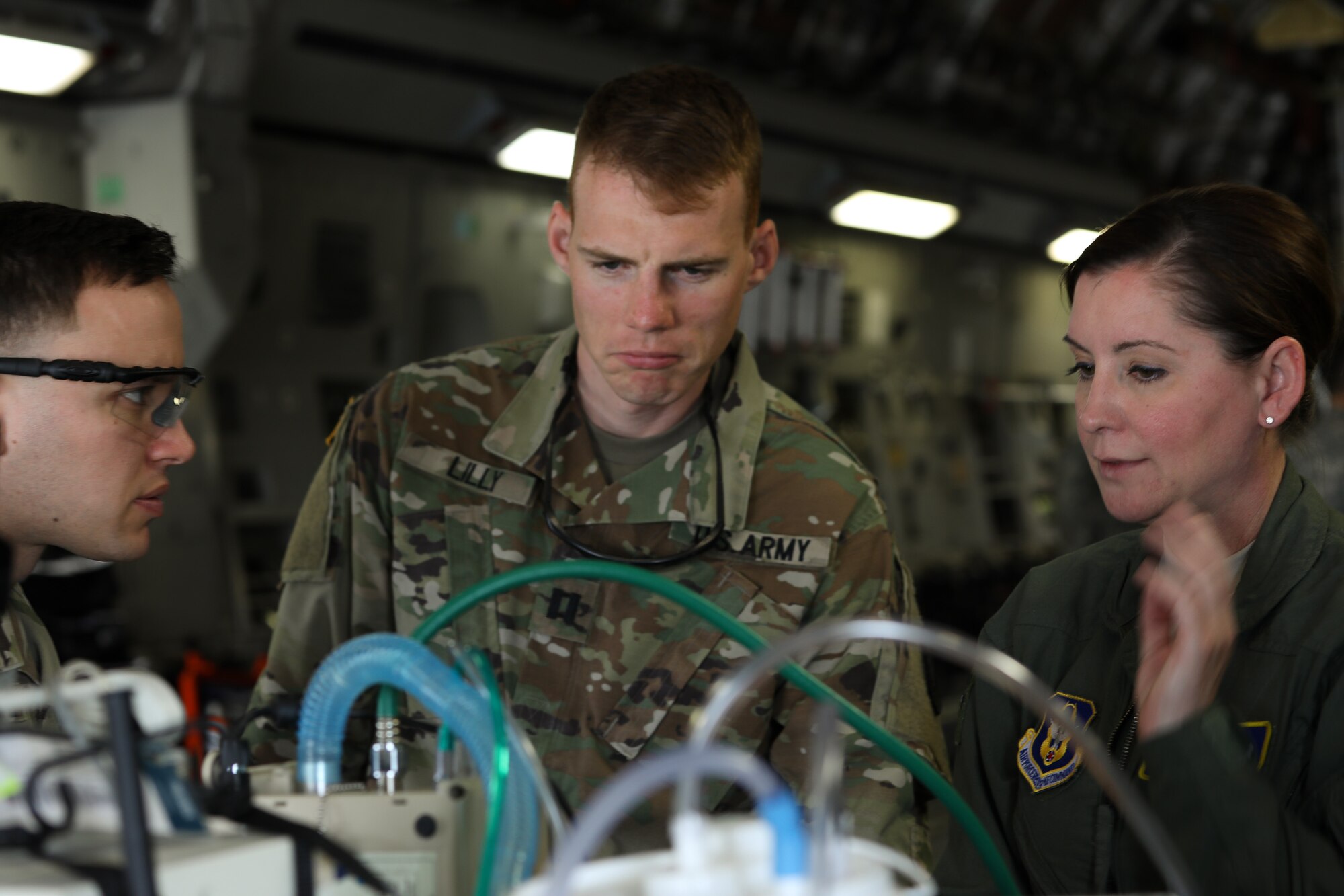 Tech. Sgt. Michelle Jorgensen discusses aeromedical equipment aboard a C-17 Globe - Master III on 25 April, 2018, at McChord Field, Wash. The 446th Aeromedical Evacuation Squadron took part in this three day capstone training event with the U.S. Army to show how patients are cared for once transported out of a combat environment.
