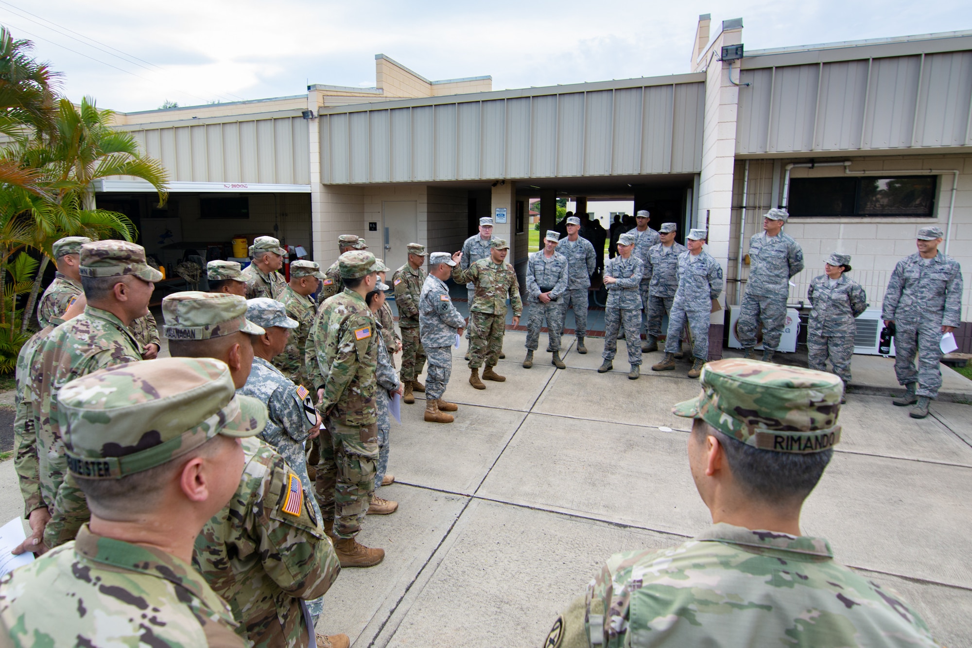 Members from the U.S. Army Reserve’s 3032nd Mobilization Support Battalion and the U.S. Air Force Reserve's 48th Aerial Port Squadron welcome each other and conduct a safety brief before they begin a joint airlift inspection training event May, 5, 2018, at Joint Base Pearl Harbor-Hickam, Hawaii. The event, which included the 3302nd MSB from Fort Shafter, Hawaii, and the Hawaii Air National Guard’s 204th Airlift Squadron and 48th APS at JBPH-H, Hawaii, was a collaborative effort to build working relationships between services, improve proficiencies, and teach participants how to inspect vehicles and cargo for airlift operations. (U.S. Army Reserve photo by Sgt. 1st Class Soo Chae)