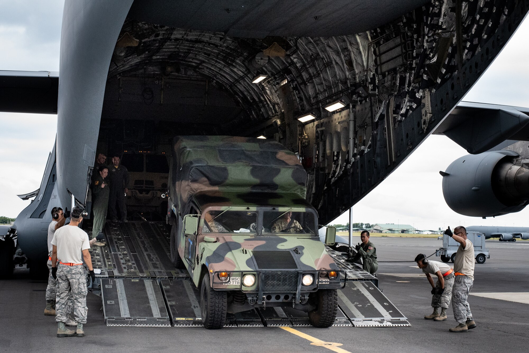Members from the U.S. Army Reserve’s 3302nd Mobilization Support Battalion and the U.S. Air Force Reserve's 48th Aerial Port Squadron load a Humvee onto a U.S. Air Force C-17 Globemaster III aircraft during a joint airlift inspection training event May, 5, 2018, at Joint Base Pearl Harbor-Hickam, Hawaii. The event, which included the 3302nd MSB from Fort Shafter, Hawaii, and the Hawaii Air National Guard’s 204th Airlift Squadron and 48th APS at JBPH-H, Hawaii, was a collaborative effort to build working relationships between services, improve proficiencies, and teach participants how to inspect vehicles and cargo for airlift operations. (U.S. Army Reserve photo by Sgt. 1st Class Soo Chae)