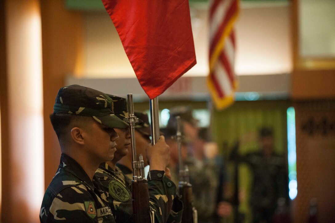 Members of the Armed Forces of the Philippines and U.S. Marine Corps color guard parade the colors during the Exercise Balikatan opening ceremony held at Tejeros Hall, Camp General Emilio Aguinaldo, Quezon City, Manila, Philippines, May 7, 2018. The ceremony represented the official commencement of Exercise Balikatan and the continued partnership between the United States and the Republic of the Philippines. Exercise Balikatan, in its 34th iteration, is an annual U.S.-Philippine military training focused on a variety of missions, including humanitarian assistance and disaster relief, counterterrorism, and other combined military operations held from May 7 to May 18. (U.S. Navy photo by Mass Communication Specialist 2nd Class Markus Castaneda)