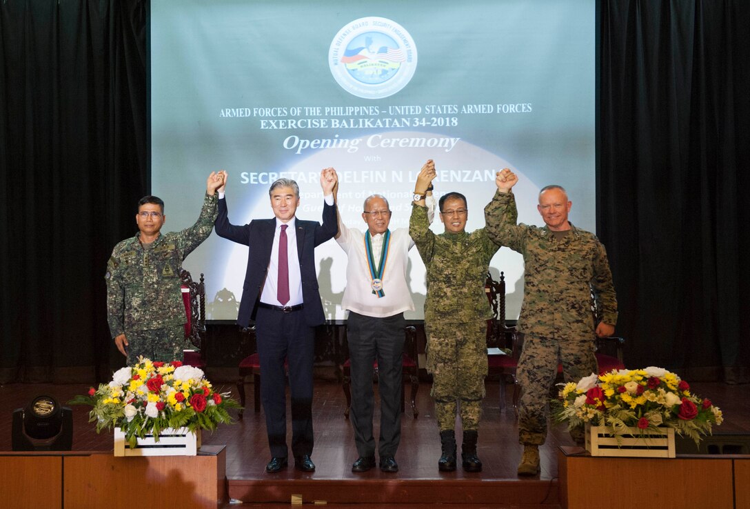 From left, Armed Forces of the Philippines Lt. Gen. Emmanuel B. Salamat, commander, Armed Forces of the Philippines Northern Luzon Command; Sung Y. Kim, U.S. Ambassador to the Philippines; Secretary Delfin N. Lorenzana, Philippine Secretary of National Defense; Armed Forces of the Philippines Lt. Gen. Carlito G. Galvez Jr., chief of staff, Armed Forces of the Philippines and U.S. Marine Corps Lt. Gen. Lawrence D. Nicholson, commanding general, III Marine Expeditionary Force raise their arms while standing shoulder-to-shoulder during the Exercise Balikatan opening ceremony held at Tejeros Hall, Camp General Emilio Aguinaldo, Quezon City, Manila, Philippines, 07 May 2018. The ceremony represented the official commencement of Exercise Balikatan and the continued partnership between the United States and the Republic of the Philippines. Exercise Balikatan, in its 34th iteration, is an annual U.S.-Philippine military training focused on a variety of missions, including humanitarian assistance and disaster relief, counterterrorism, and other combined military operations held from May 7 to May 18. (U.S. Navy photo by Mass Communication Specialist 2nd Class Markus Castaneda)