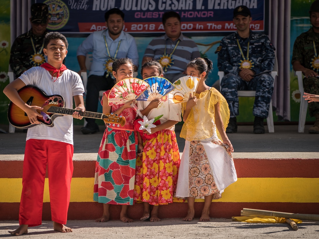 Students perform a song and dance for multinational service members, school faculty and staff, and honored guests during the groundbreaking ceremony at Cabu Elementary School in Cabanatuan City, Nueva Ecija, Philippines, in support of Exercise Balikatan, April 20, 2018. Balikatan 34-2018, in its 34th iteration, is an annual U.S.-Philippine military training exercise focused on a variety of missions, including humanitarian assistance and disaster relief, counterterrorism and other combined military operations held from May 7 to 18. (U.S. Marine Corps photo by Sgt. Matthew J. Bragg)