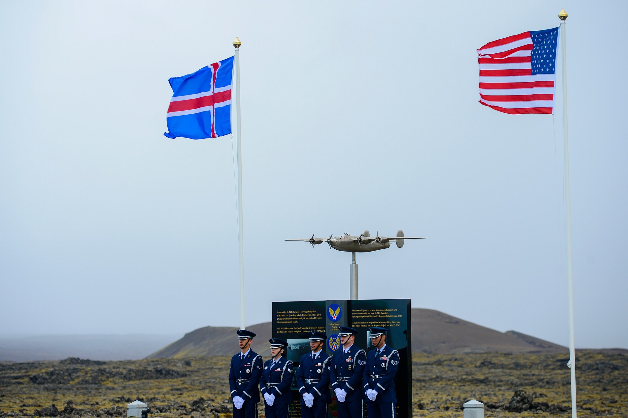 Airmen assigned to the Spangdahlem Air Base Honor Guard pose for a photo in front of a monument dedicaed to Lt. Gen. Frank Maxwell Andrews and his crew, May 3, 2018, in Keflavic, Iceland. The ceremony recognized the 75th anniversary of the crash of a B-24 Liberator which resulted in the death of Andrews and 13 members of his crew. (U.S. Air Force photo/Staff Sgt. Kenny Holston)