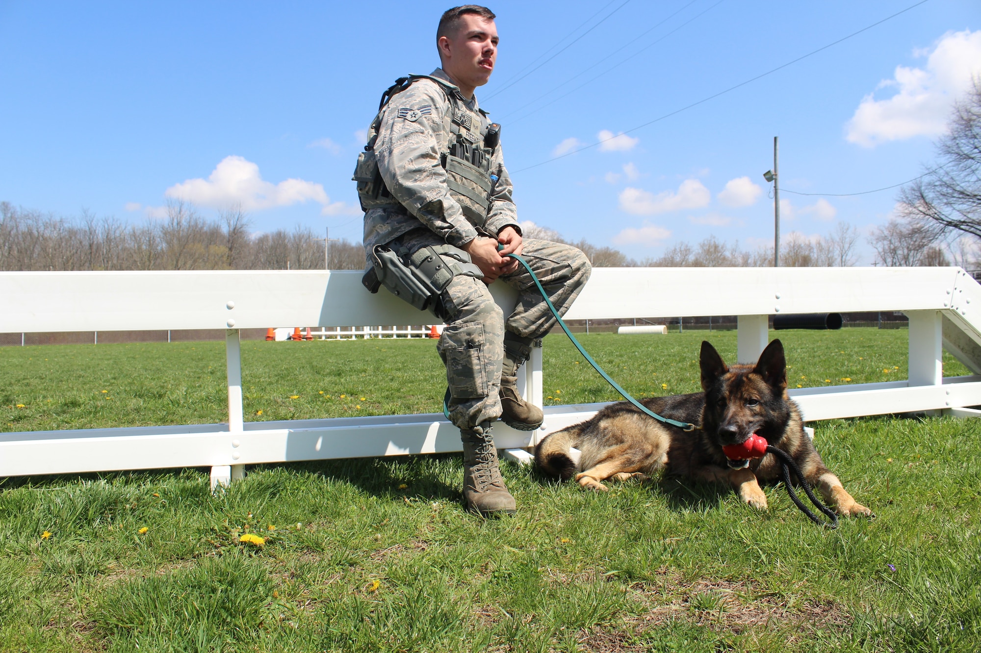 Senior Airman Marshall Freeman, 88th Security Forces military working dog handler and his partner Sonny take a break in between training. To become a MWD handler, potential handlers must first have experience in Security Forces and obtain a recommendation from a kennel master before they can be considered for the position. Once selected, they are sent to Joint Base San Antonio-Lackland to learn MWD patrol, basic training, detection and first aid. (U.S. Air Force photo/Stacey Geiger)