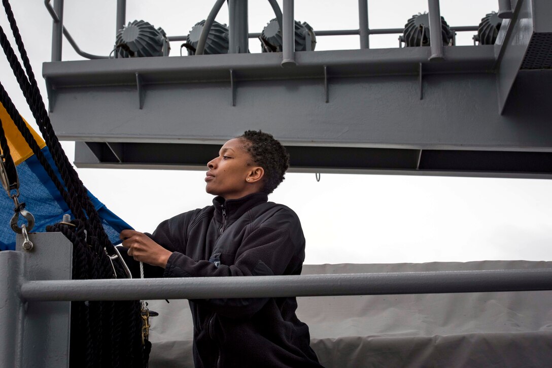 A sailor secures a flag aboard the aircraft carrier USS George H.W. Bush.