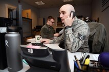 U.S. Air Force Staff Sgt. Zachary Boomer, 100th Force Support Squadron outbound assignments technician, takes a phone call, at RAF Mildenhall, England, April 17, 2018. Airmen in the military personnel flight are responsible for ensuring Airmen across base have their records squared away and are deployment ready. (U.S. Air Force photo by Senior Airman Christine Groening)